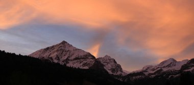 Bright lit clouds over mountains near Gstaad, Switzerland.