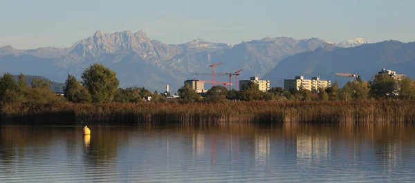 stock image Wetzikon, town in Zurich Canton, shore of Lake Pfaeffikersee and mountain ranges.