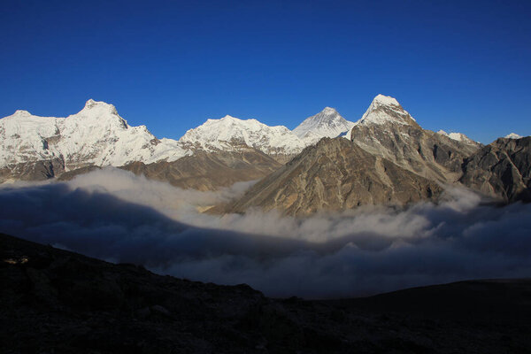 Mt Everest and other high mountains surrounded by a sea of fog, Nepal.