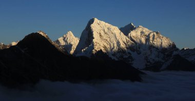 Snow covered peaks of Mt Ama Dablam, Cholatse, Taboche and Tobuche. clipart