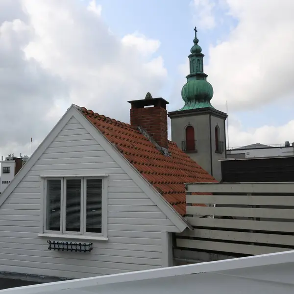 Stock image Roofs of old houses and church tower in Stavanger, Norway.