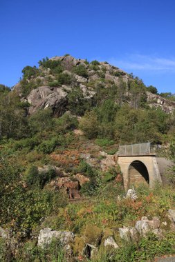 Railway tunnel entrance and fun park like anorthosite rock formation, Egersund, Norway. clipart