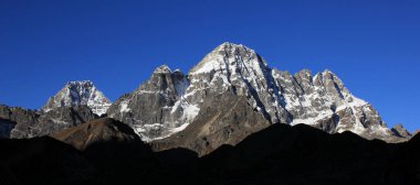 Sunrise view from Dragnang. Azure blue sky over high mountains, Nepal. clipart