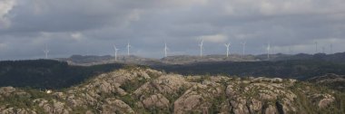 Anorthosite rock formations and windmills, Egersund, Norway. clipart