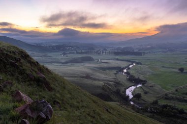 Low clouds in the valley before sunrise Southern Drakensberg South Africa clipart