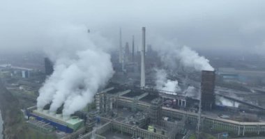 Large factory, smoke, chimney pipe and smog, metal industry, blast furnace and large facility. Fumes and CO2 in the atmosphere.