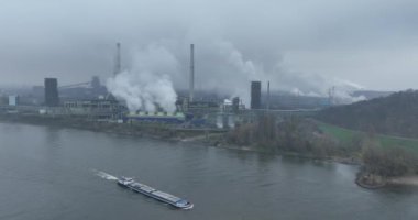 Manufacturing steel, blast furnace, along the rhine river in the ruhr area in Germany. Europe. Inland shipping by vessel.
