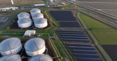 Eemshaven, Het Hogeland, The Netherlands. Wind turbines, petrochemical industrial silos, solar panels, fossil vs sustainable energy.