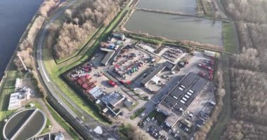 Recycling yard, processing of discarded consumer materials and product. Multiple container for waste streams, metal, wood, electronics, paper, etc. Aerial overhead view