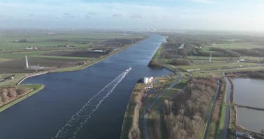 Aerial footage of the North Sea Canal, also known as the Noordzeekanaal, captures the beauty and industrial significance of this important waterway in the Netherlands. Near Velsen.