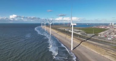 Rotterdam, 19th of January 2023, The Netherlands. Eneco wind turbines along the beach on the Rotterdam Maasvlakte generate clean, renewable energy using wind power technology.