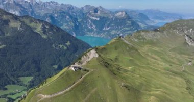 Aerial drone footage of Fronalpstock hike and cable car showcases the stunning alpine scenery and the technology of the cable car infrastructure. Aerial