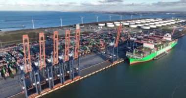 Rotterdam, 19th of January 2023, The Netherlands. Aerial drone video of a cargo ship and container crane in action, showcasing the efficiency of loading and unloading operations at a busy port. Aerial