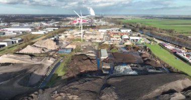 Scrapyard landfill site, junk collection and burry of waste under grond on a large pile. Aerial drone overhead view.