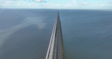 Spectacular drone footage of the Afsluitdijk, capturing the stunning dike and its beautiful surroundings, showcasing the breathtaking landscape, windmills, and historic cultural heritage