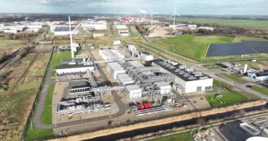 High altitude aerial drone footage of an underground gas storage facility near Alkmaar, showcasing the vast infrastructure and its surrounding landscape.