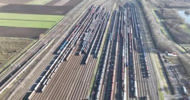 Breathtaking aerial perspective of a locomotive depot, highlighting the efficiency and activity of the workers and machinery involved in rail maintenance.