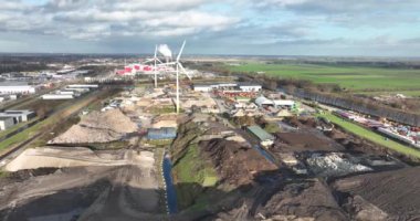 Scrapyard landfill site, junk collection and burry of waste under grond on a large pile. Aerial drone overhead view.
