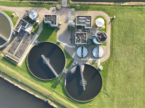 From above, the intricate network of pipes, tanks, and filtration systems at a waste water treatment plant are displayed in stunning detail.