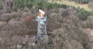 Discover the hidden radar tower in the midst of a lush green canopy, blending seamlessly into its natural surroundings.