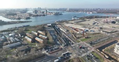 An aerial perspective of Amsterdams engineering marvel, the Piet Hein Tunnel, with bustling roads and busy trams flowing seamlessly underneath.