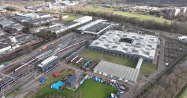 Overhead footage captures the intricate logistics and organization required to keep a public transport system running smoothly, as vehicles undergo cleaning, inspection, and testing.