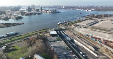 A birds eye view of Amsterdams stunning infrastructure, with a busy intersection and the Piet Hein Tunnel and canal providing seamless connectivity.