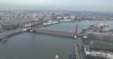 A breathtaking panorama of the Willemsbrug, capturing its impressive scale and modern architecture against the backdrop of Rotterdams cityscape.