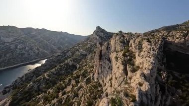 FPV yarış insansız hava aracı Fransa 'daki bir Calanque veya Calanche karasularının tepelerinde uçuşların videosu.