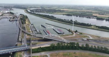 Aerial drone video showcasing the Zwarte Waalseburg at the Theemswegtrac , the Rozenburgsebrug, and the captivating surrounding water and infrastructure. Rotterdam