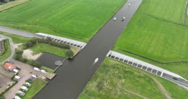Hollanda, Friesland 'daki bir su kanalı altyapısının havadan aşağı görüntüsü. Suyun altındaki yol.