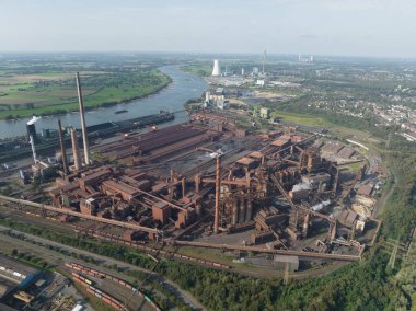 Heavy metal industry, blast furnaces, one of the largest steelworks in Germany, high chimneys, which are part of the sintering plant. Duisburg, Germany aerial drone view. clipart