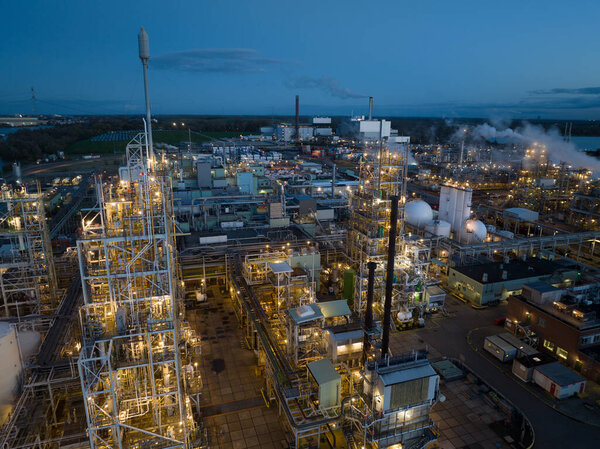 aerial drone view of a polymere production facility in Dordrecht, The Netherlands at night. Close up view of the installation
