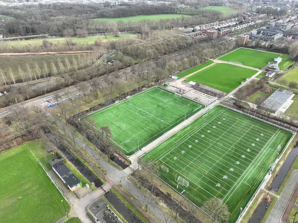 aerial drone video of amateur sports and recreation in The Netherlands. Sport clubs and fields, accomodation and facilities, soccer and american football. Aerial.