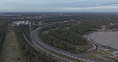 Mobilite endüstrisi için hava aracı görüntüsü test pistinde. Test sürüşü alanı devresi. Asfaltta köşeleri düzleştirir.