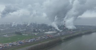 Belçika 'nın Antwerp limanındaki hava kuşları sigara dumanı, ağır sanayi ve bulutlu hava koşullarını vurguluyor..