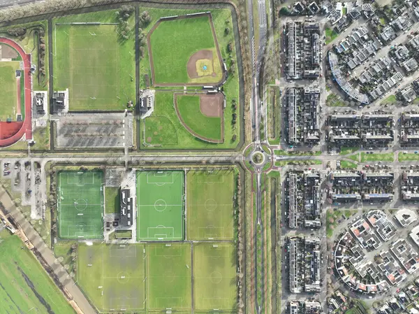Aerial drone top down view on sports field, amateur sports grounds. Birds eye top down overview. Recreation leisure and health lifestyle. The Netherlands.