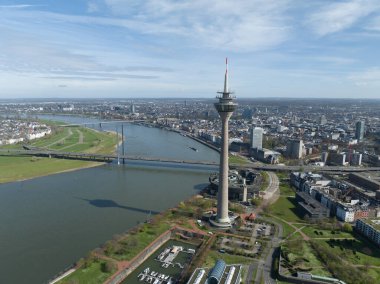 Aerial drone view on the city skyline of Dusseldorf, Germany. City skyline, tv tower, rheinknie bridge, Rhine river and urban infrastructure. clipart