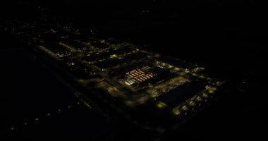 Aerial birds eye view on a large datacenter at night. Internet infrastructure.