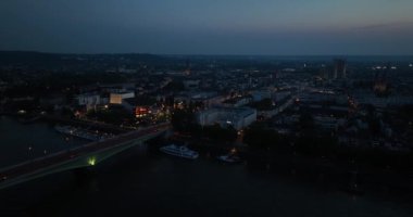 Aerial drone view over the city of Bonn, Germany. City along the rhine river at night. Birds eye view.
