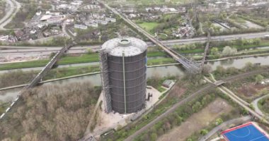 Gasometer Oberhausen is a large gas holder in Oberhausen, Germany. Now a museum. Industrial heritage, aerial drone view.