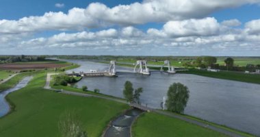 Aerial birds eye view by drone on a hydroelectric power plant in The Netherlands. Generation of electric energy by the flow of water.