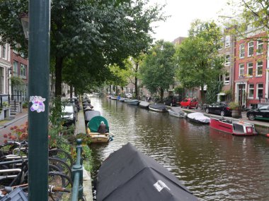 Amsterdam, Kuzey Hollanda, Hollanda, 2 Ekim 2024: Fotoğraf Amsterdam, Hollanda şehir merkezinde çekildi. Kanallar ve kanal evleri. Şehir sokakları.