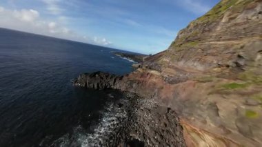 Azores 'un kayalıkları ve kıyıları Sao Miguel, Portekiz, Atlantik okyanusu, güneşli istikamet, dinamik Fpv insansız hava aracı uçuşu, dağ sörfü. Havadan.