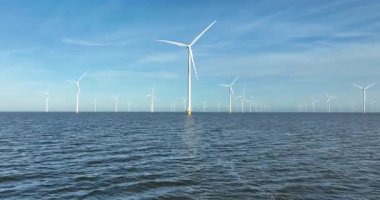 Suyun üzerindeki Afsluitdijk 'te rüzgar türbinleri rüzgarın kinetik enerjisini sürdürülebilir elektrik enerjisine rüzgar çiftliklerine ve Hollanda' da yenilenebilir enerjiye dönüştürür. Hava aracı görünümü.