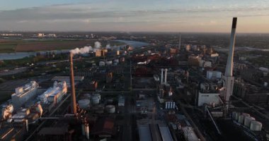 Almanya 'nın ruhr bölgesindeki sanayi bölgesinde gün batımında baca dumanı yığıyor. Hava aracı görüntüsü. Üretim ve üretim, endüstriyel, imalat.