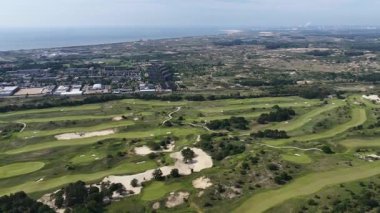 Noordwijkse golf kulübü, Northwijk Golf Kulübü, kum tepelerinde yeşil golf sahası. Çimenler ve yeşiller, 18 delik, sığınaklar, spor ve eğlence. Hava videosu.