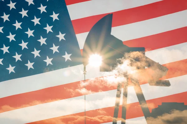Oil pump on background of flag of usa.Silhouette oil drilling pump on background of united states flag.Double exposure.Sunset,us flag background.