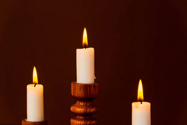 Three candles on a candlestick.Old wooden table.Beautiful Religious background.Religion concept.