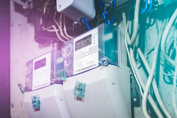 stock image Kilowatt hour electric meters, power supply meters.Close-up of modern smart grid residential digital power supply meter.Indoors shot.Selective focus.Toned.